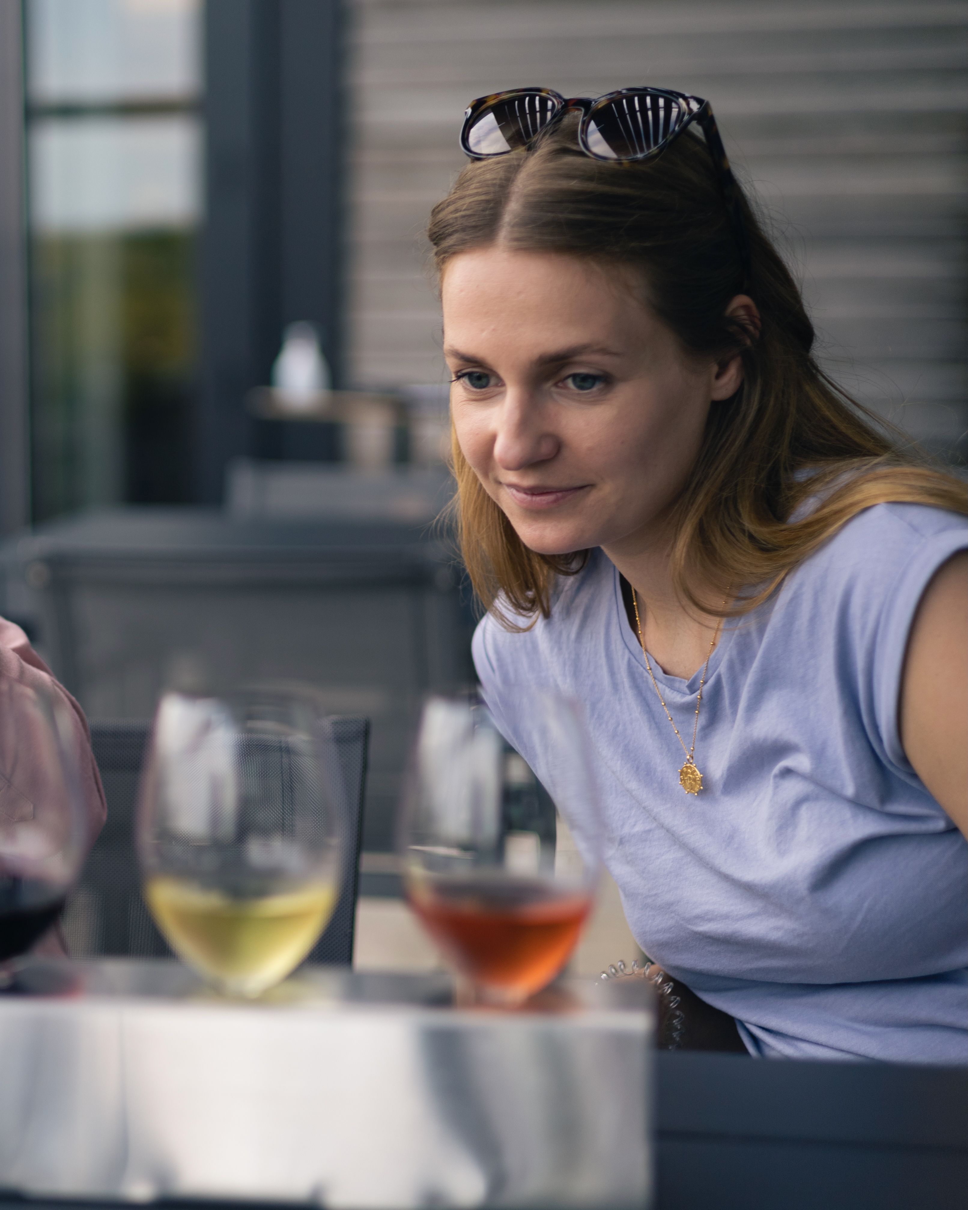 A woman looking at a wine tasting flight