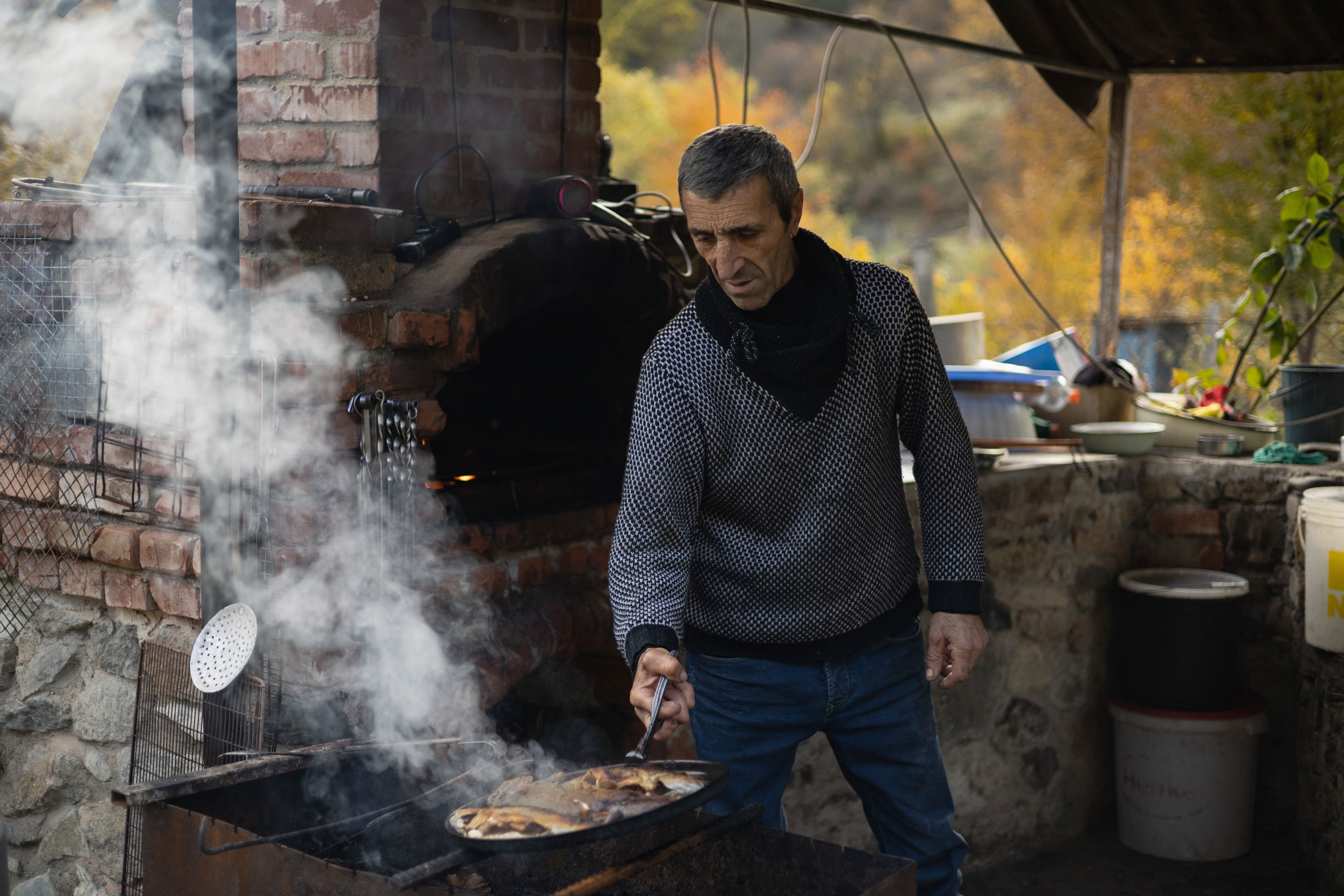 A man frying fresh trout