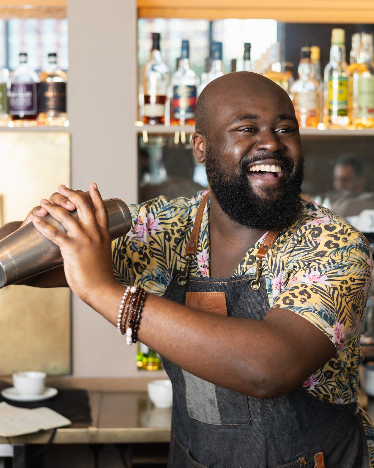 A bartender shaking a cocktail