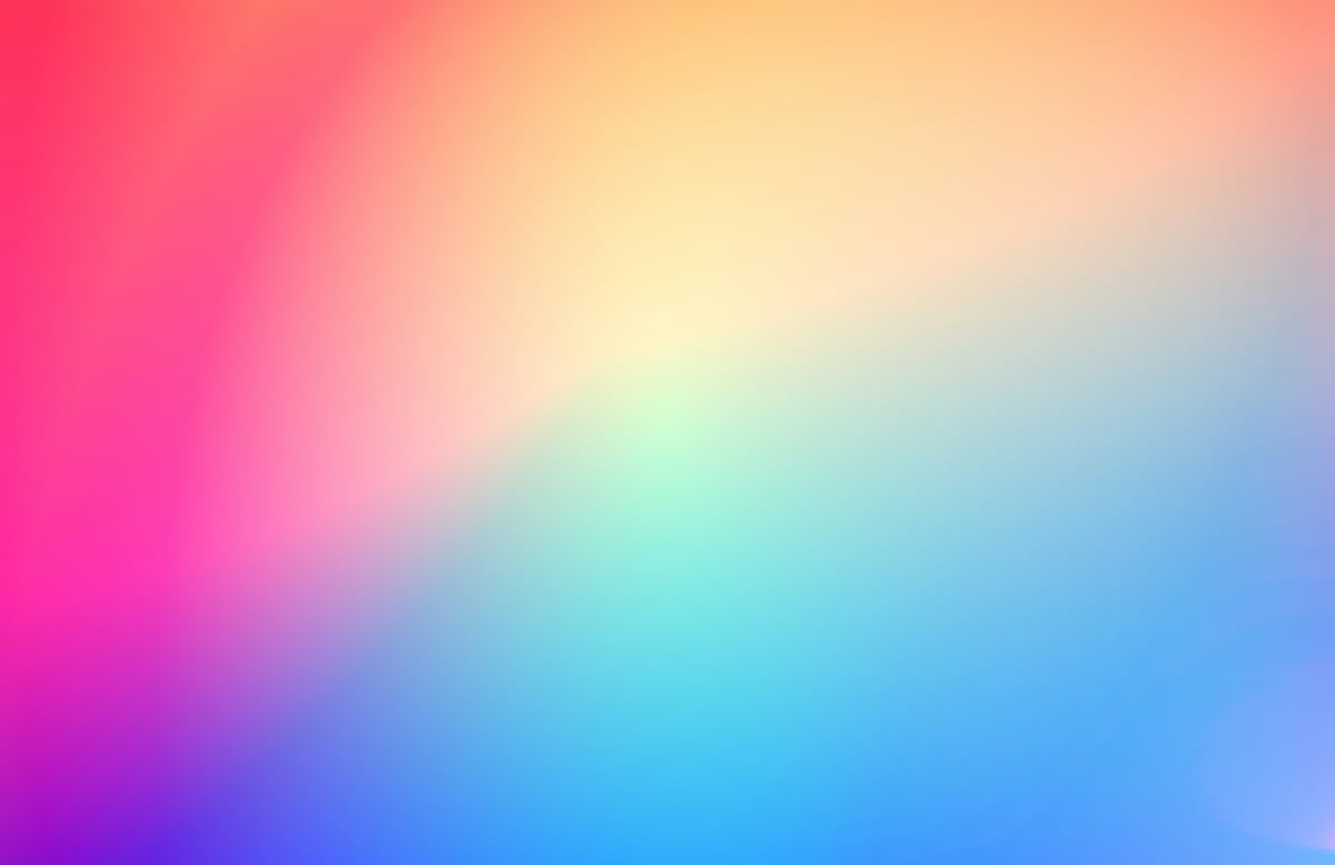 Smooth, vibrant color gradient blending from magenta and peach into cyan and blue.