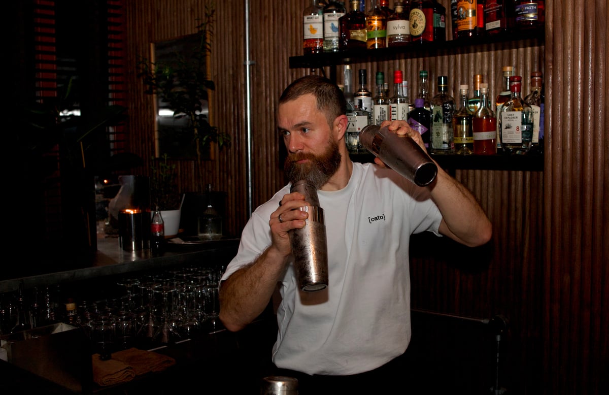A bartender shaking two cocktails at the same time at The House of Julep in Covent Garden