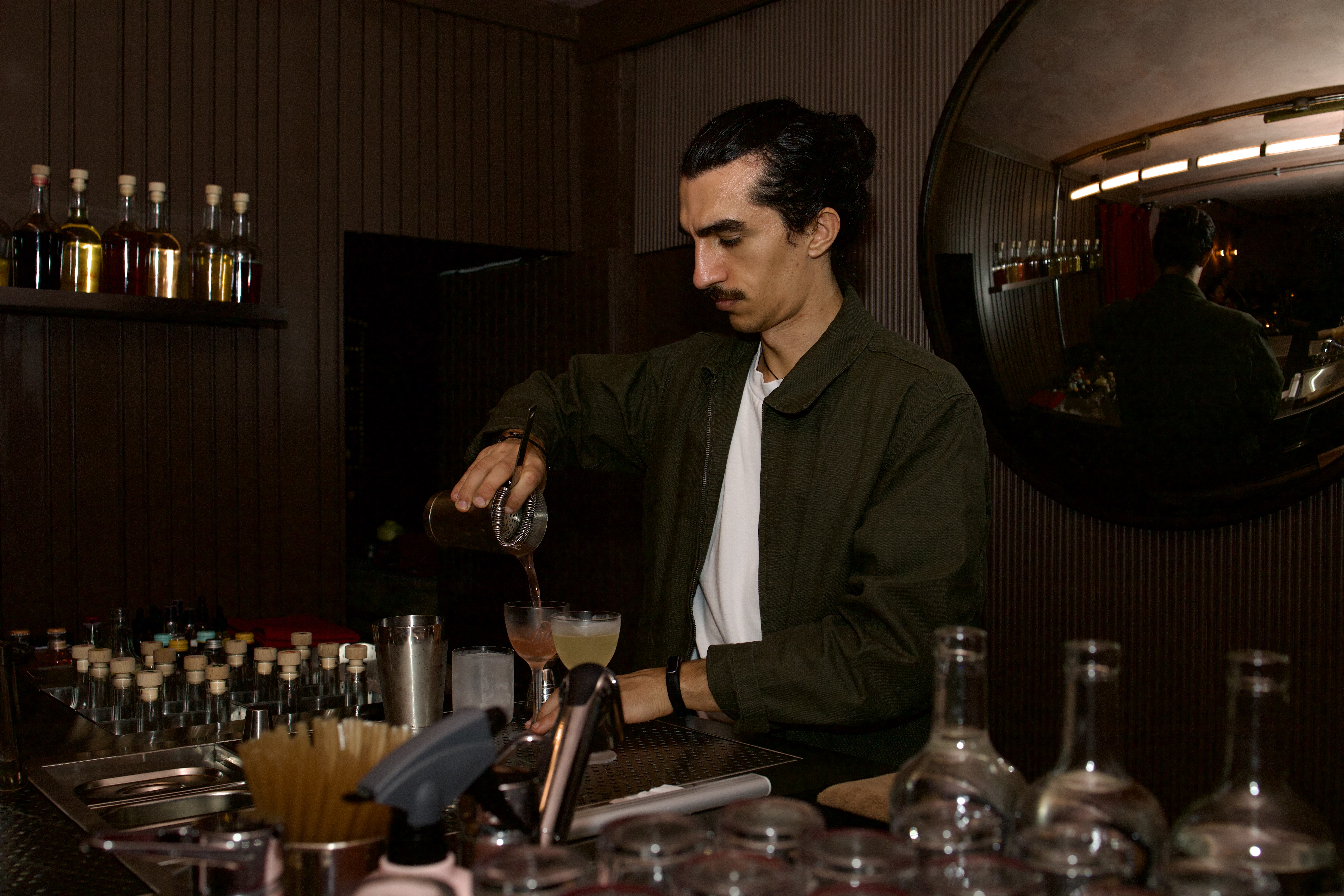 A bartender at cato in Covent Garden making cocktails